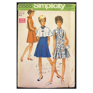 May include: Simplicity pattern number 8685 for a dress, featuring three models wearing different styles of the dress. The dress is available in sizes 12 and 34. The pattern is from 1970 and costs 85 cents.