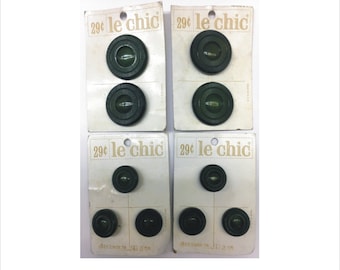 May include: Four cards of green plastic buttons with the text "29¢ le chic" on each card. The buttons are different sizes and have a raised design.