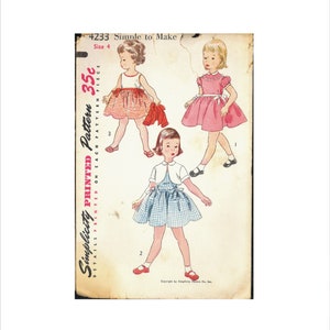 May include: A vintage Simplicity sewing pattern for a girl's dress. The pattern is for size 4 and costs 35 pence. The pattern shows three different styles of dresses, all with a simple design. The pattern is printed on a white background with red and black text.