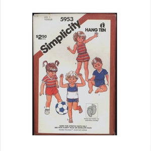 May include: Simplicity sewing pattern number 5953 for Hang Ten toddler clothing. The pattern includes three designs: a red and white striped shirt with red shorts, a blue and white tank top with blue shorts, and a blue shirt with blue shorts. The pattern is sized for stretch knits only.