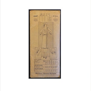 May include: A vintage sewing pattern for a dress with a wrap style and a belt. The pattern is printed on a tan paper with a black and white illustration of the dress. The pattern number is 5447 and the price is 35 cents. The pattern is for sizes 14, 32, 35, and 40.