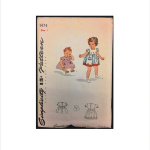 May include: Simplicity 1474 pattern for a girl's dress. The pattern includes two dresses, one with a blue and white print and the other with a pink and white print. The pattern is for sizes 15 and 16.