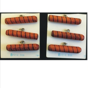 May include: Six wooden buttons with brown and orange stripes. The buttons have a metal loop for sewing. The buttons are labeled "B3216-30N".