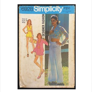 May include: Vintage Simplicity Designer Fashion sewing pattern, size 12, featuring illustrations of women's clothing. The cover has a blue header with the number 6928 and the Simplicity logo. The illustrations depict a yellow halter top and shorts, and a pink jacket and shorts.