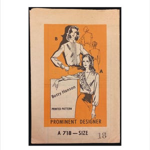 May include: Vintage sewing pattern featuring illustrations of women's blouses and skirts. The pattern is by Betty Hanson, a prominent designer, and is size 18. The background is orange with black text and illustrations.