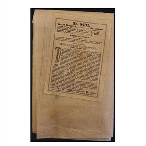 May include: A vintage pattern for men's drawers, with a waist measurement of 34 inches. The pattern is from The Butterick Publishing Co. and is priced at 85 cents. The pattern includes instructions and a diagram of the garment.