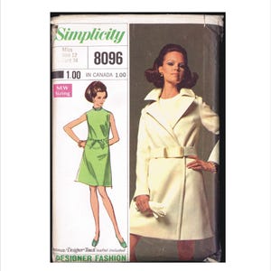 May include: A vintage Simplicity sewing pattern, featuring a woman in a cream-colored coat and a green dress. The pattern number is 8096, with the text "Designer Fashion" at the bottom. The pattern is for Miss size 12, bust 34.