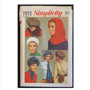 May include: Vintage Simplicity sewing pattern 7872 for a hooded hat and five different styles of berets. The pattern is for one size and is printed on a white background with red and black text. The pattern shows five different women wearing the hats.