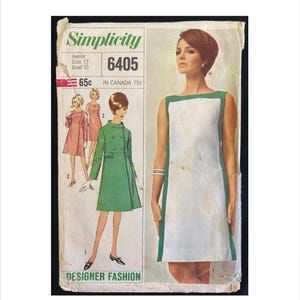 May include: Simplicity sewing pattern number 6405 for a junior size 13 dress with a bust measurement of 84 cm. The pattern includes three different dress styles, one with a green and white colour block design, one with a green coat, and one with a pink dress. The pattern is labelled "Designer Fashion".