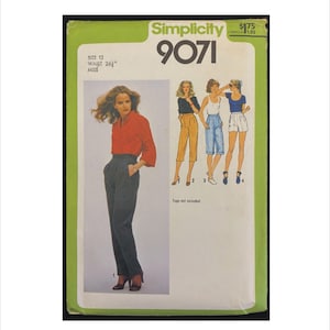 May include: Simplicity 9071 sewing pattern featuring a woman in a red shirt and gray pants. The pattern includes illustrations of different outfit options. The text on the pattern reads "SIZE 12 WAIST 26" MISS".