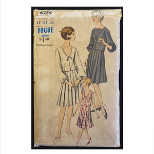 May include: Vintage Vogue pattern envelope with illustrations of three dresses. The envelope is tan with the number 6254 at the top. The Vogue logo is visible, along with bust and hip measurements. The dresses are in shades of white, grey, and red.