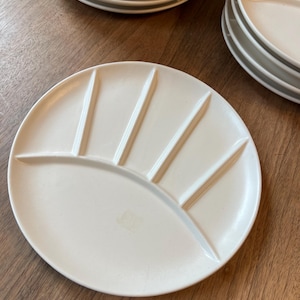 May include: A white ceramic plate with five sections, ideal for serving a variety of dips or sauces.