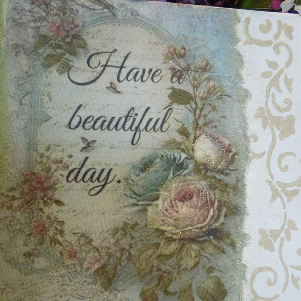 Canvas with "have a beautiful day" decoupaged  and surrounded by flowers and stenciled on the side