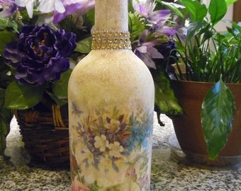Flowers on wine bottle decoupaged and decorated