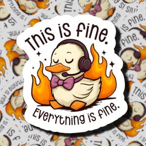 May include: A die-cut sticker featuring a cartoon duck wearing a purple bow tie and black headphones with a microphone. The duck is surrounded by orange and yellow flames. The text reads "This is fine." at the top and "Everything is fine." below.