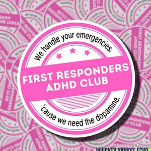 May include: A circular sticker with a pink and white design featuring the text "We handle your emergencies, FIRST RESPONDERS ADHD CLUB, 'cause we need the dopamine." The design includes three small stars and horizontal line accents.