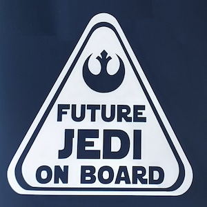May include: White triangular warning sign with a black Rebel Alliance symbol and the text "FUTURE JEDI ON BOARD".