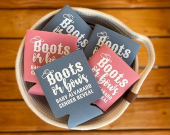 May include: A basket of six blue and pink beverage insulators with the text "Boots or Bows" and the words "Baby Alvarado Gender Reveal" on one of the blue insulators.