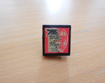 South Seas Tiki Bar Tie pin/Lapel Pin! Black scrabble tile pin featuring favorite Tiki establishments, Tiki-culture, Tiki Oasis