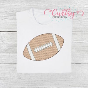 May include: A brown and white embroidered football design on a white t-shirt.
