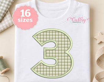 May include: A white t-shirt featuring a large number 3 with a light green and white gingham pattern. A pink scalloped badge on the upper left displays the text 16 sizes, and the text Curtsy Embroidery appears in the upper right corner.