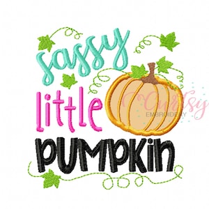 May include: A fall-themed design featuring a pumpkin and the words "sassy little pumpkin." The pumpkin is orange with a brown stem and green leaves. The text is in teal, pink, and black, with green vines.