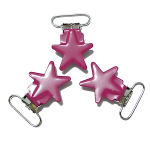 May include: Three magenta star-shaped suspender clips with silver metal hardware. The clips are arranged in a triangular pattern against a white background. Each star has five points.