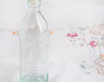 Biberón vintage de los años 70: decoración infantil de vidrio transparente con leche