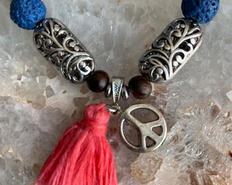 Royal blue navy lava rock stone and pink tassel peace charm bracelet