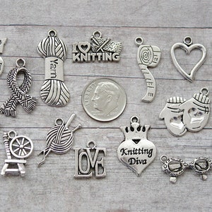 May include: A collection of 15 silver-toned metal charms with knitting-themed designs. The charms include yarn, needles, a spinning wheel, scissors, a measuring tape, mittens, and hearts with the words "Knitting Queen", "Knitting Diva", "Yarn", "I Love Knitting", and "Love".