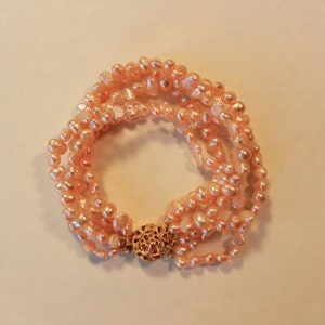 Vintage Five Strand Hand Knotted Warm Pink With Hints Of Copper, Irregular Pearls Bracelet With Gold Tone Round Box Clasp