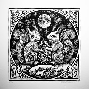 May include: Black and white woodblock print of two squirrels sharing a pine cone under a full moon. The print is framed with a decorative border and includes the artist's signature and the year 2019.