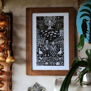 May include: A black and white illustration of a couple sitting on a bench under a tree. The illustration is framed in a wooden frame and hanging on a wall.