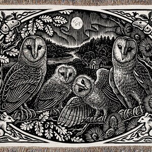 May include: Black and white woven tapestry featuring a family of owls in a forest setting. The owls are perched on branches with a full moon in the background. There are two mice in the bottom corners of the tapestry.