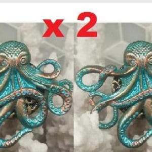 May include: Two octopus-shaped decorative cabinet knobs. Each knob is a detailed sculpture with a teal and bronze finish. The image has a red "x 2" in the top center, indicating two knobs are available.