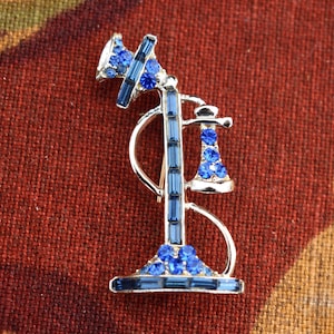 1910 Candlestick Pin on a 1980s Brooch with Blue Sparkle