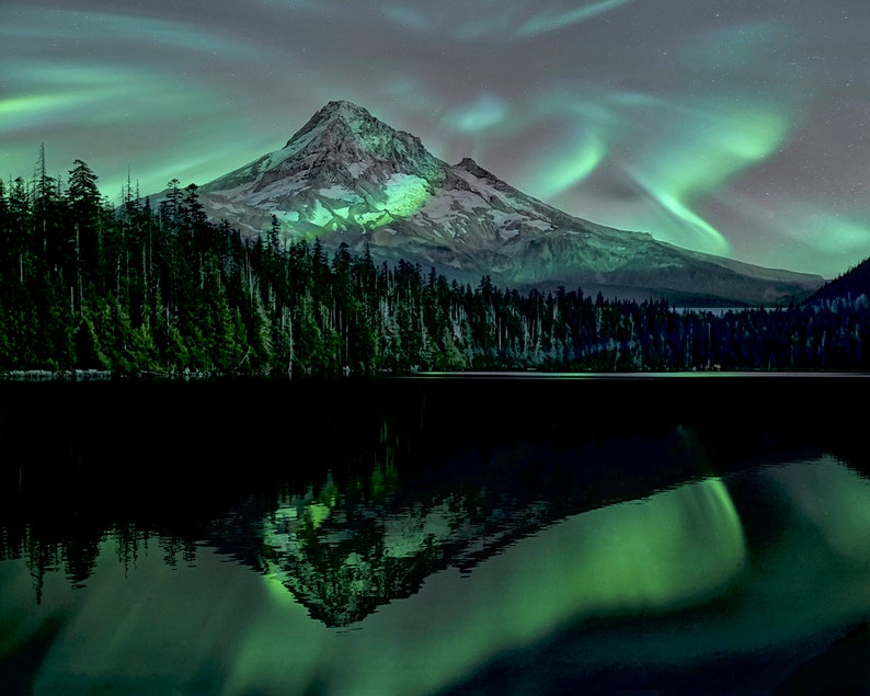 May include: A mountain peak with snow-capped summit reflected in a still lake. The sky is filled with vibrant green aurora borealis.