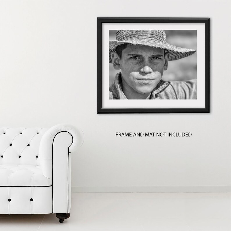 May include: Black and white framed portrait of a person wearing a straw hat. The person is looking directly at the camera. The frame is black, and the mat is white. The text "FRAME AND MAT NOT INCLUDED" is below the frame.