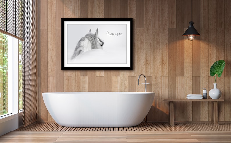 Pu&ograve; includere: Una fotografia in bianco e nero di una testa e un collo di cavallo, con il testo "Namaste" stampato sull'immagine. La fotografia &egrave; incorniciata e appesa a una parete in un bagno con una vasca da bagno bianca e un pavimento in legno.