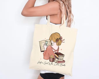 May include: A beige tote bag with a graphic of a woman reading a book and a stack of books. The text on the bag reads "Just a Girl Who Loves Books".