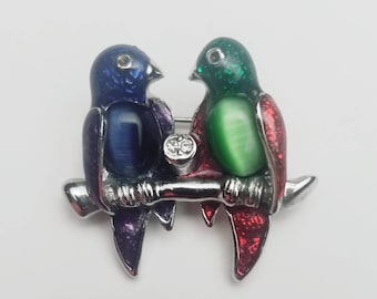 Vintage brooch with pair of colorful jelly belly parrots on a perch