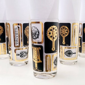 Mid century cocktail tumblers of trivets in black and gold on clear glass, set of six