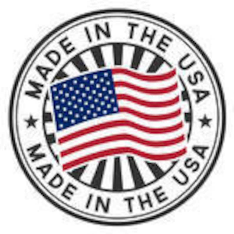May include: Circular sticker with the text "MADE IN THE USA" in a black font around the perimeter. The center features the American flag with red and white stripes and a blue field of white stars.