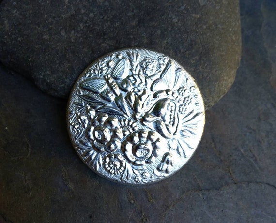 The Twisted Eye Silver Plated Medalion with Flowers and Butterflies Stamping Made in the USA