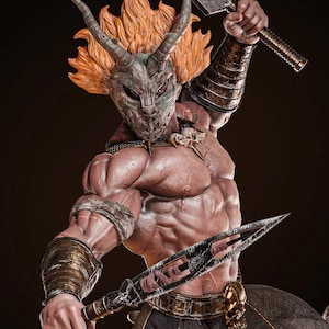 May include: A detailed statue of a muscular warrior figure, wearing a horned mask and holding two bladed weapons. The figure has orange hair and is clad in bronze-coloured armour. The statue has a dark background.
