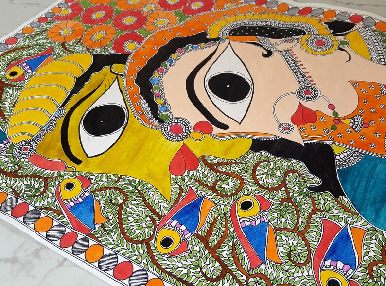 May include: A colorful painting depicting a couple with large eyes, surrounded by intricate floral patterns and birds. The artwork is done in a traditional Indian style, with vibrant colors and detailed lines.