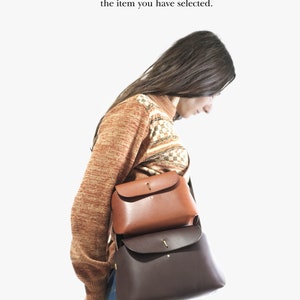 May include: Two leather handbags, one brown and one dark brown, are worn by a person. The text "Mini vs Standard" is at the top of the image. The text "This picture is for size differentiation only. It does not necessarily represent the item you have selected." is below the title.
