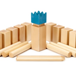 May include: A wooden game set with a blue crown on top of a wooden block. The set includes 10 wooden blocks and 5 wooden sticks.