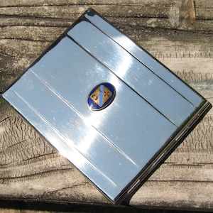 Vintage Art Deco Silver Metal  &quot;Monos&quot; Foil Stickered Hinged Cigarette Case, Guilloché Enameled Crest or Emblem, Great Condition, Smokes