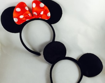 May include: Two black mouse ear headbands with red and white polka dot bows. One headband has a bow on top and the other headband has the bow on the side.